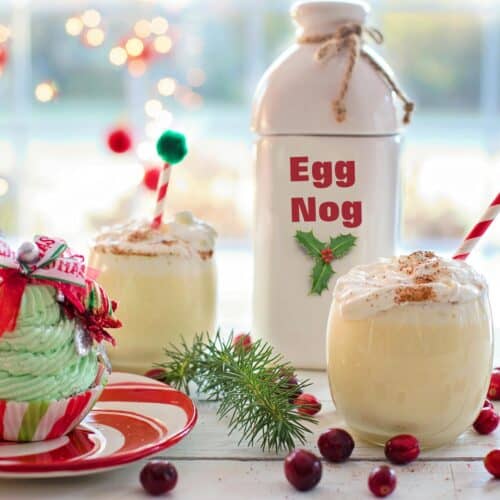 2 glasses of Non-Alcoholic Eggnog with a bottle in the background