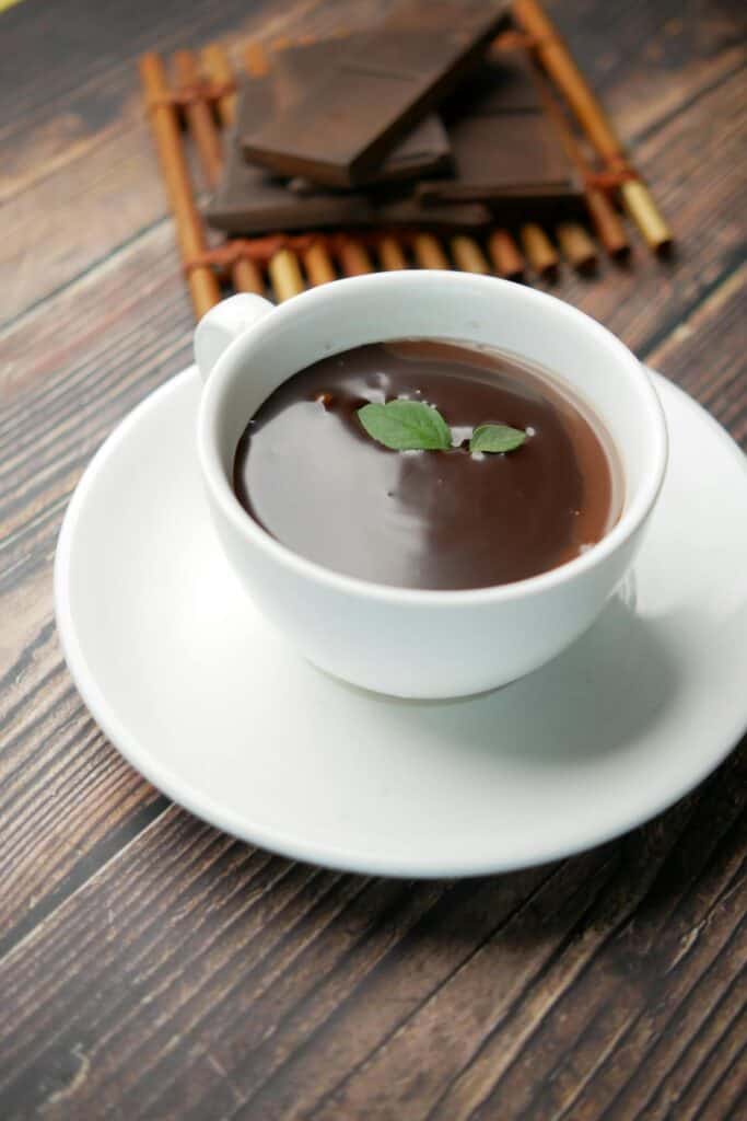 Hot peppermint chocolate garnished with a mint leave